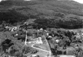 Aerial Photograph of Neighborhood Nestled Next to Wooded Hillside