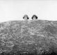 Women Peaking over Rock For Picture