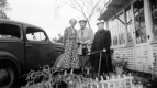 Three Women Posing for Picture Outside House
