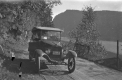 Automobile Driving Alongside a Lake