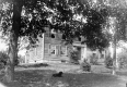 Clapboard House with Dog in Yard