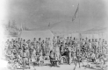 Soldiers at a camp in front of mountains