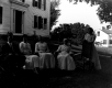 Women and Man in front of House