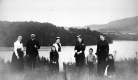 Children, Men and Women in front of a Lake