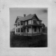 White Wooden-Framed Home and Outbuildings