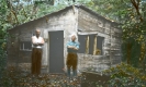 Two Men in front of a Cabin