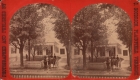 Horse drawn carriage in front of white building