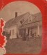 Several people in front of wood-frame house