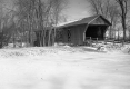 Snowy scene with covered bridge