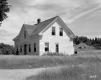 White House in Field Next to Dirt Driveway/Road