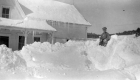 Young boy on large pile of snow