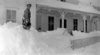 Young boy standing on large snow pile