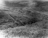 Aerial of forested area and Norwich University in the distance