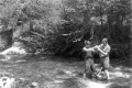Two Norwich cadets plumb lining a river