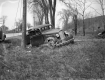 A Damaged Car next to a Utility Pole