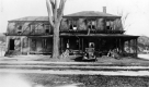 Automobile in front of wood-framed house