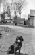 A Dog chained in a dirt yard