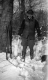 A Vested Hunter with Rabbit Carcasses