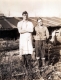Two men standing near lumber