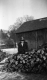 Woman near a woodpile at the Fletcher Farm