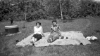 Women sunning in a field 