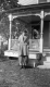 Young woman in front of Fletcher farmhouse porch
