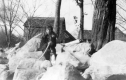 Young woman on rocks behind Mrs. Fletcher's house