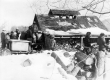 A group of people around a wood shed