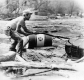 A man trying to get barrels out of water