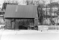 Wooden-frame barn in a snowy scene
