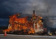Wooden-frame dwelling engulfed in flames