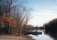 Still water with a boat and trees
