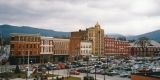 Crowded parking lot in front of brick buildings