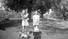 Two Young Girls Playing With Dolls