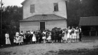 Children in Front of Wooden-frame Building