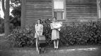 Two Girls in Front of a House