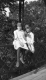Two Girls Sitting on a Fence