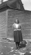 Woman in Front of Home