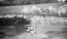 Two Girls Swimming in a Lake