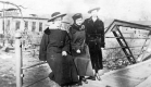 Three Women Sitting on a Bridge