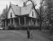 Boy with bicycle in front of home
