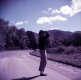 Women Standing Along Dirt Road