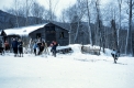 Skiers Outside a Small Wooden Lodge
