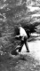 Boy fishing near shrubs