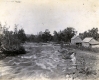 Rushing River and a wooden-frame building