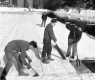 Three men cutting ice