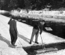 Two Men working to cut ice