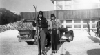 Two Skiers in front of Building