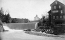 Waterfall and wooden-frame buildings