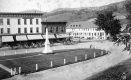 Horse-drawn carriages in front of buildings
